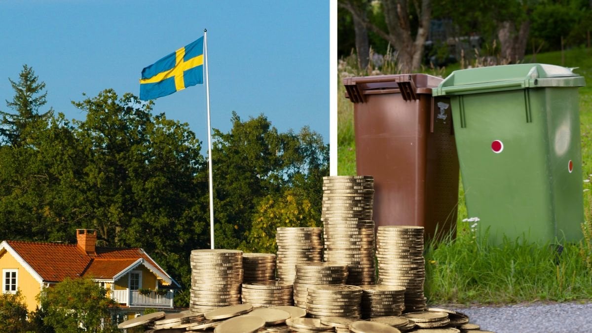 Hus med sverigeflagga och soptunnor.