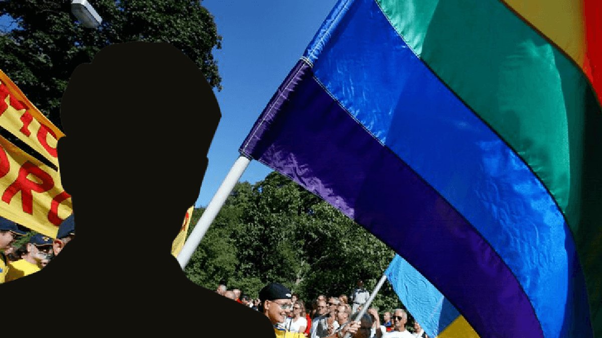 Svart silhuett mot bild på Pride-firande människor.
