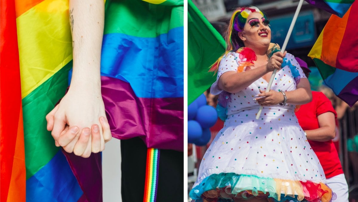 Två händer möts framför en pride-flagga. 