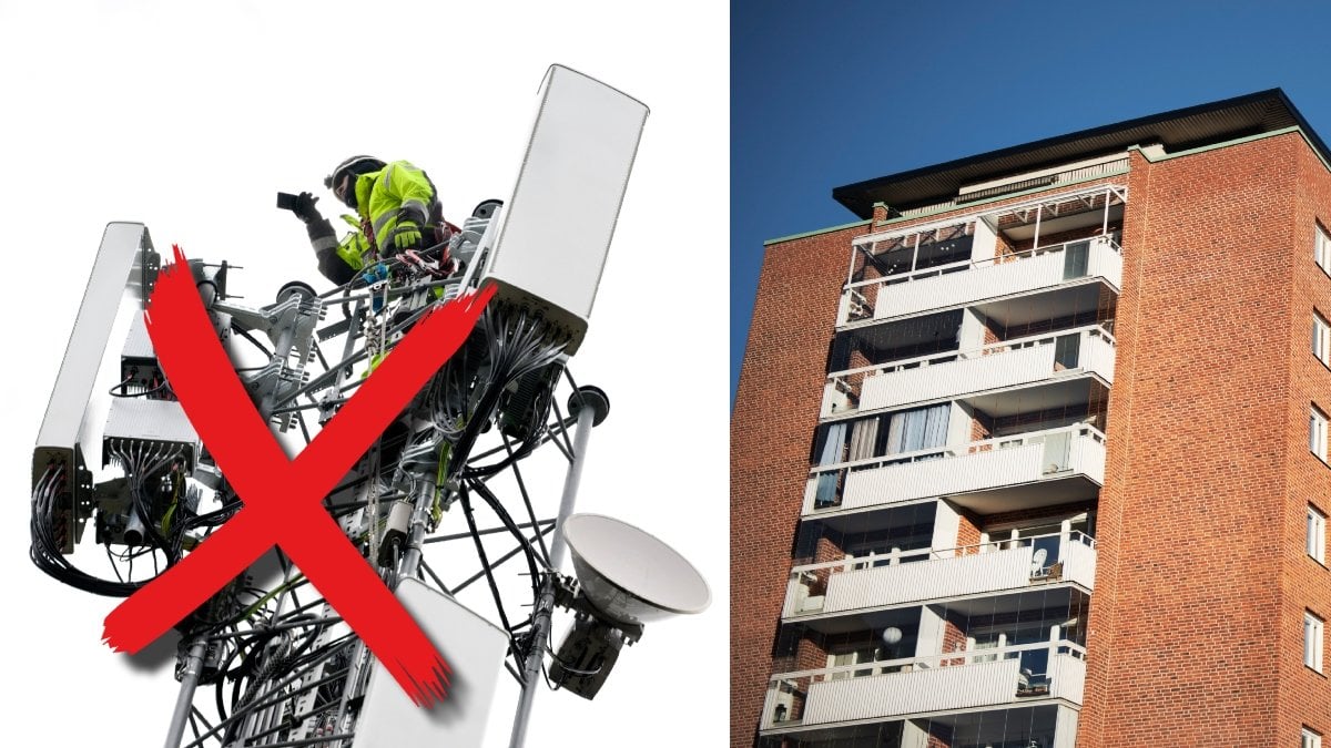 En man som arbetar på en mobilmast och ett flerfamiljshus i soligt väder.