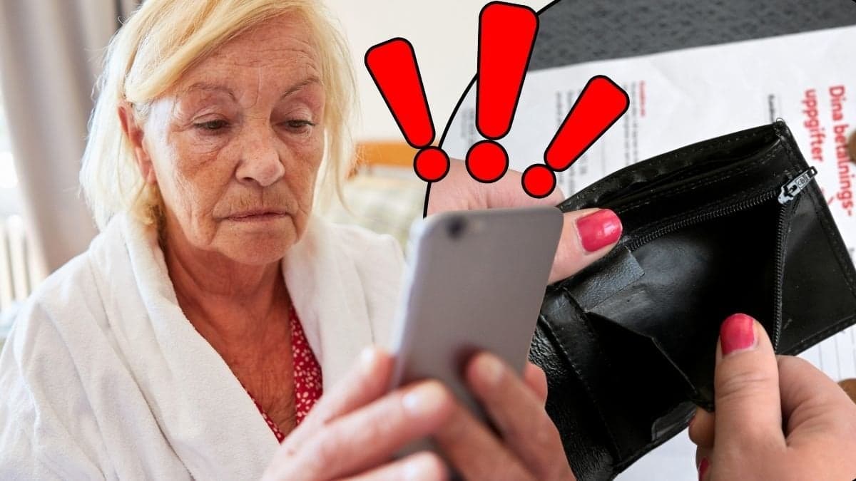 Kvinna med mobiltelefon i handen och en tom plånbok med räkningar i bakgrunden.