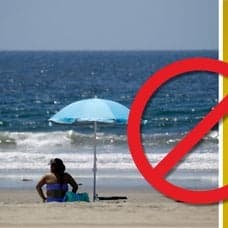 Kvinna på strand i USA och smittvarning.