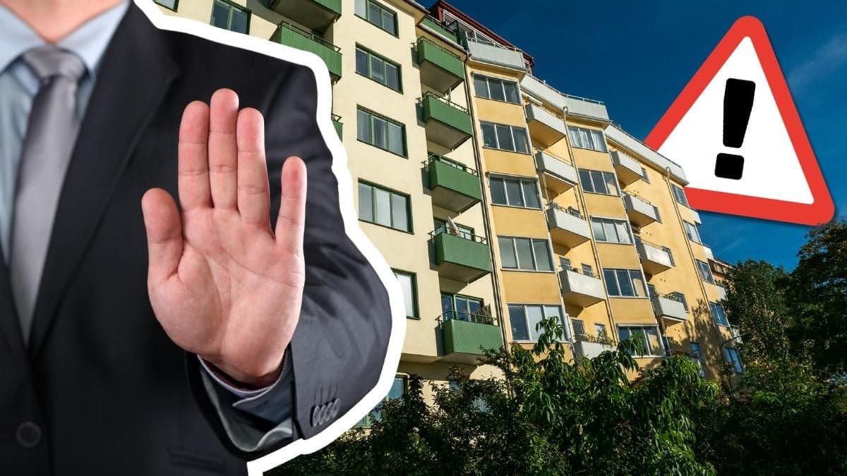 Hand som säger stopp och balkonger på solig fasad