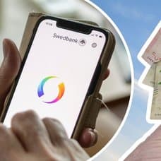 Swish-appen i mobil och svenska sedlar i hand