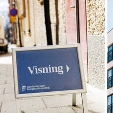 Visnings-skylt vänster. Lägenhetshus höger.
