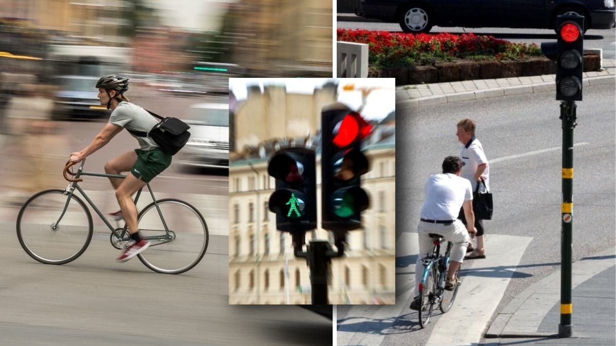 Cyklist och cyklist som står vid trafikljus.