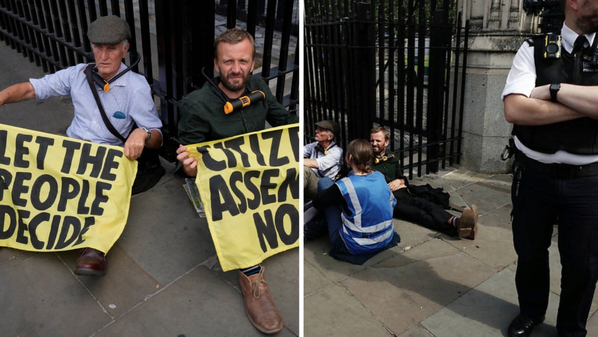 Aktivister genomför en klimatprotest vid det brittiska parlamentet. Här har två personer låst fast sig vid en grind utanför.