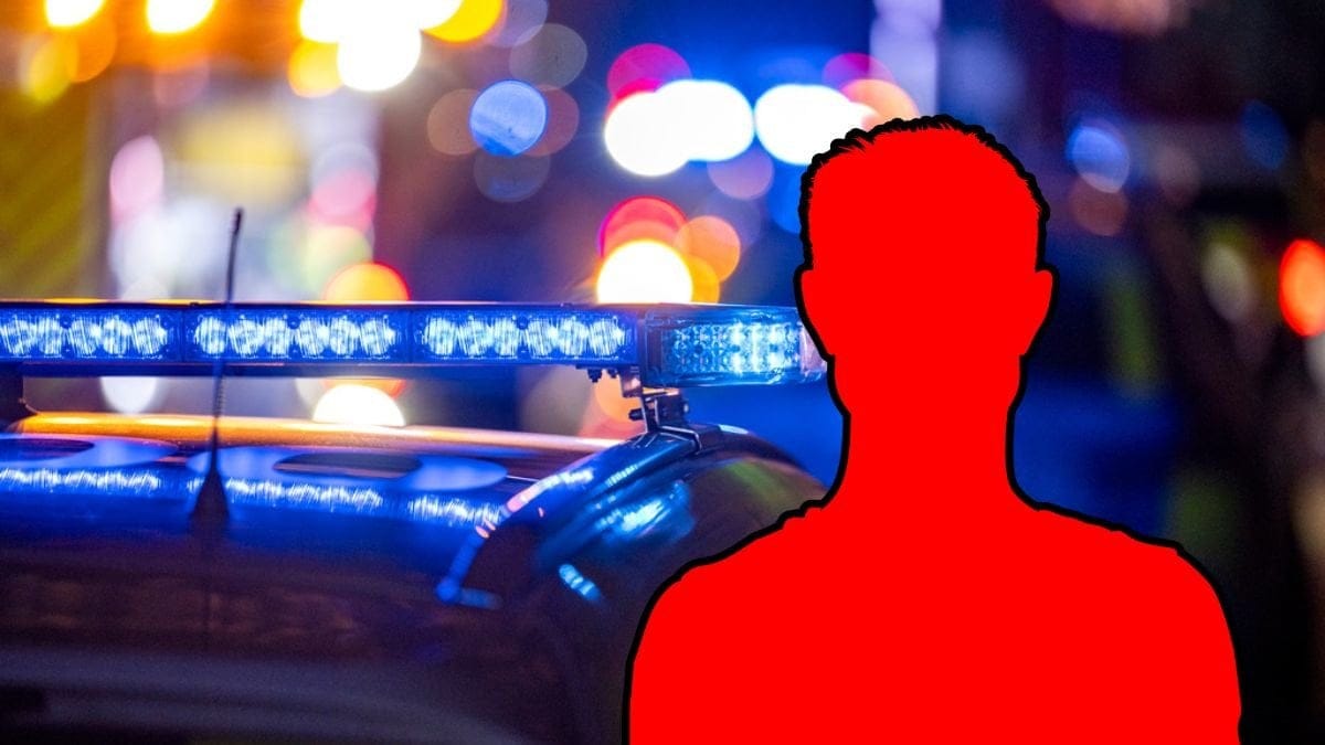 Polisbil och siluett av en man.